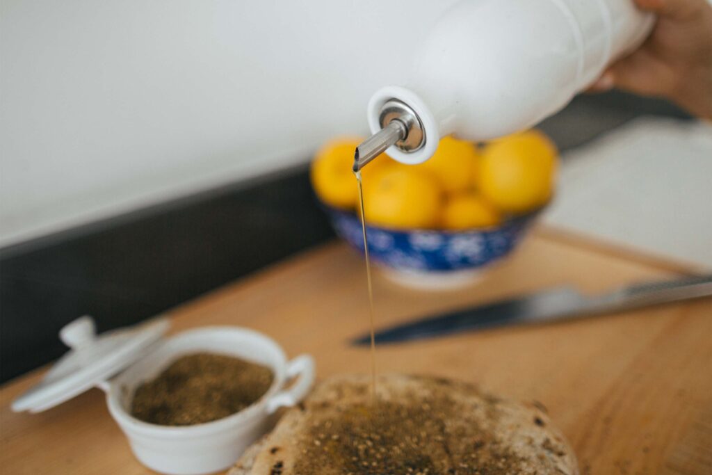 A person is pouring something into a bowl.