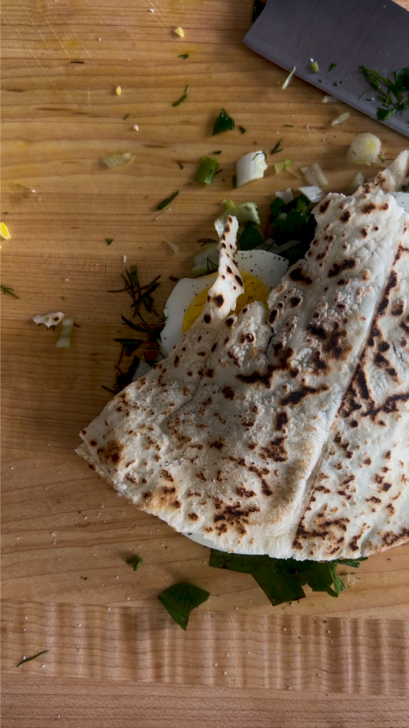 A tortilla sitting on top of a wooden table.