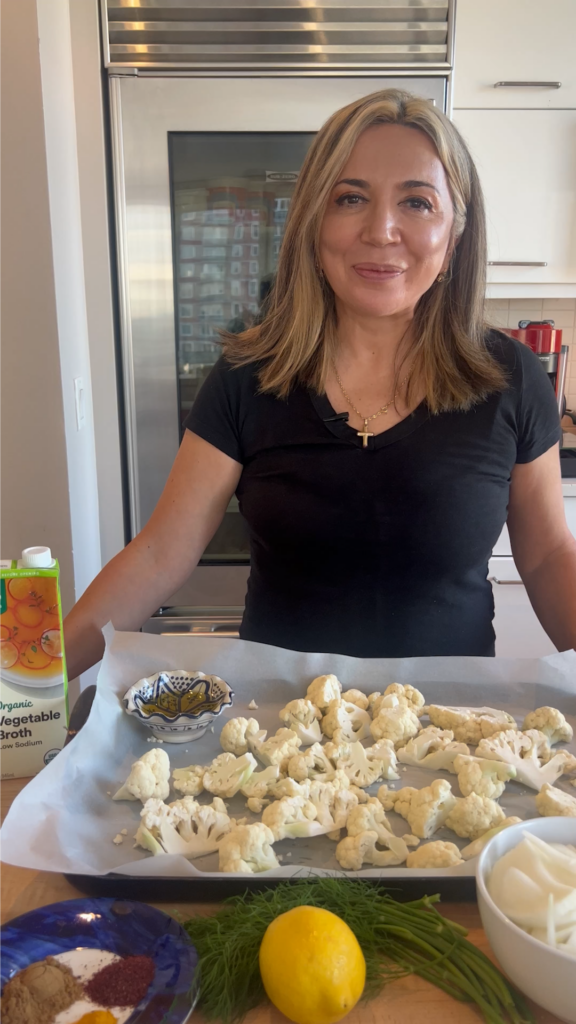 A woman sitting in front of some food on a table