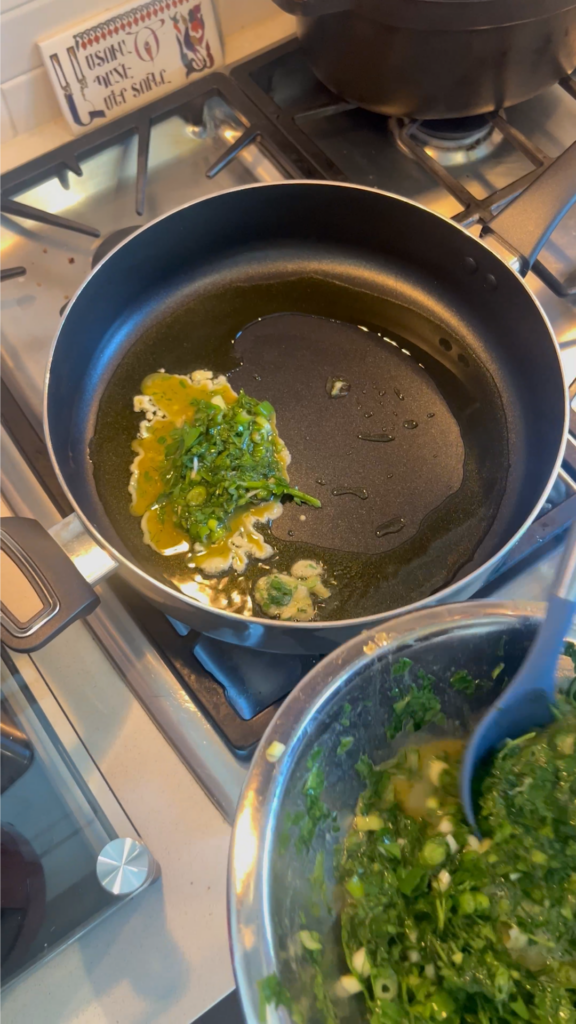 A pan with some green onions in it