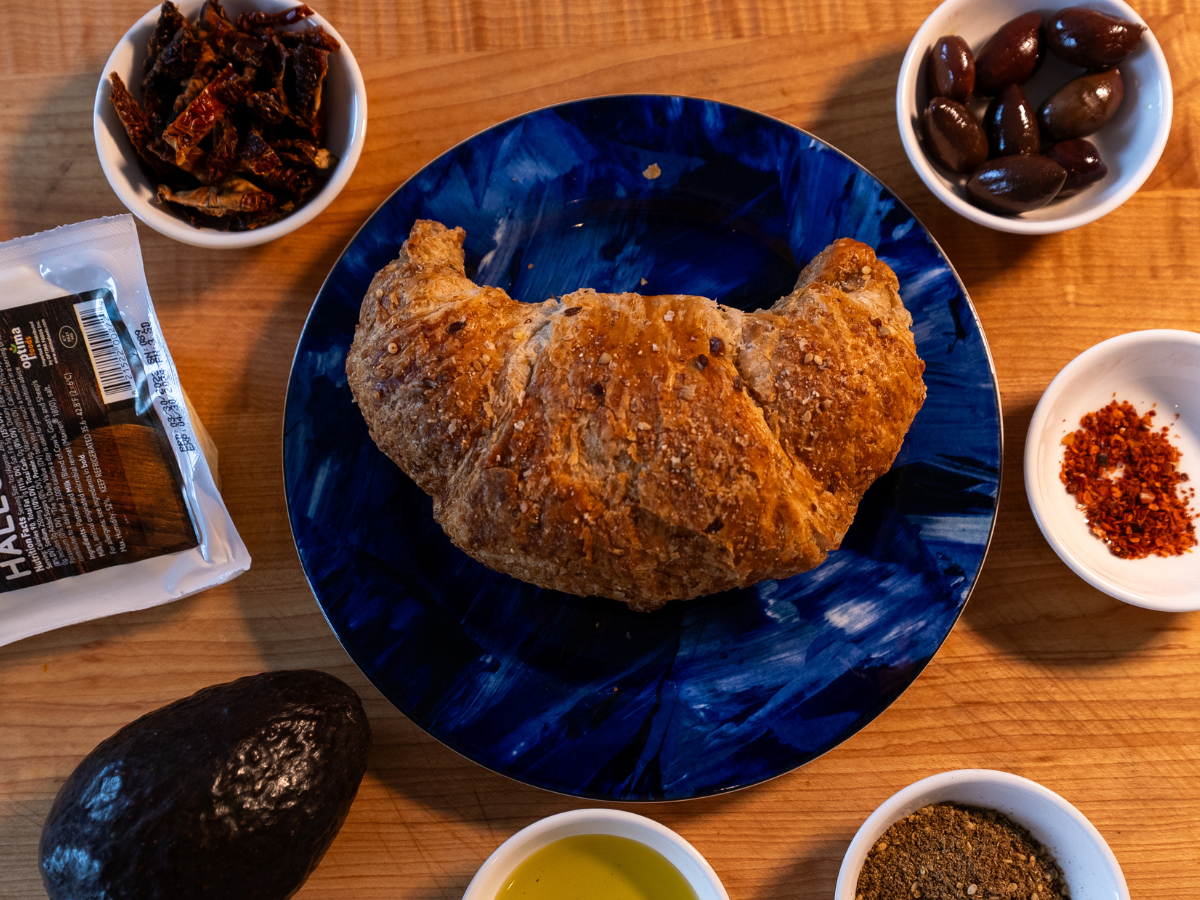 A blue plate with some bread and other food on it