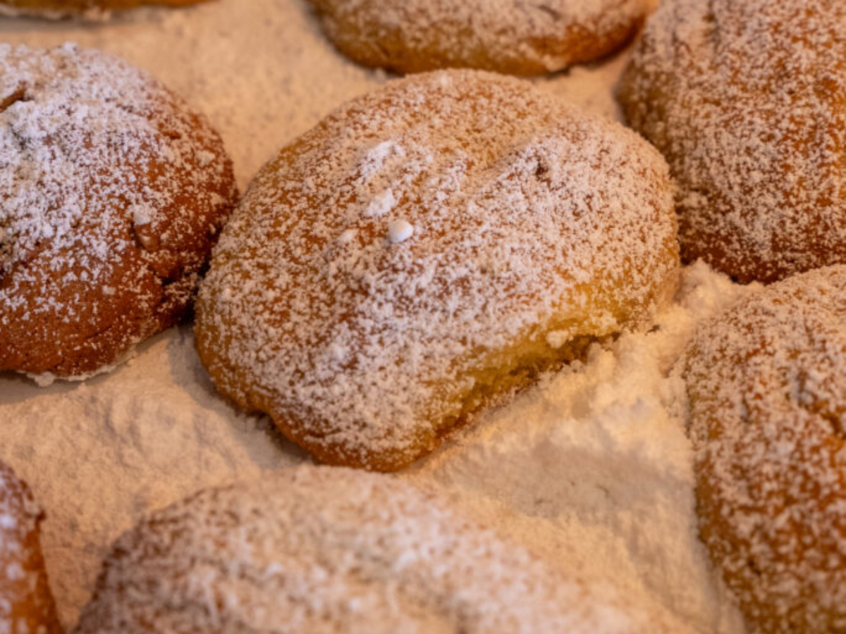 A close up of powdered sugar covered cookies