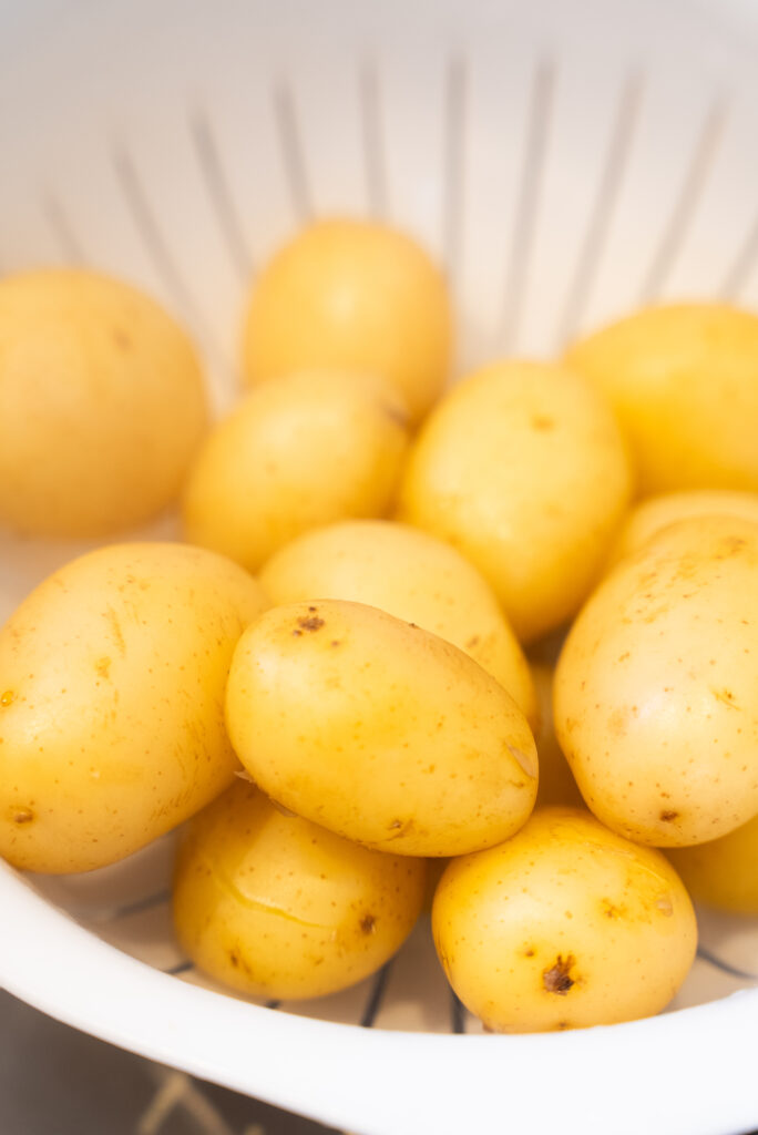 A bunch of potatoes and green beans on the table