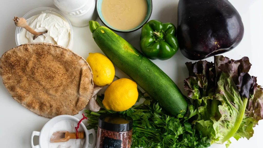 A table topped with lots of food and vegetables.