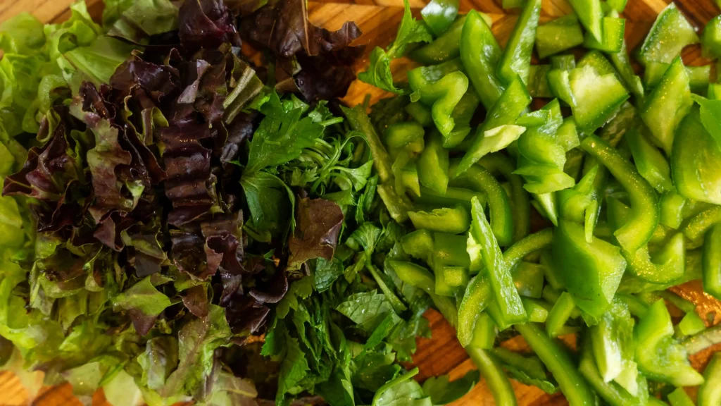 A table topped with lots of food and vegetables.