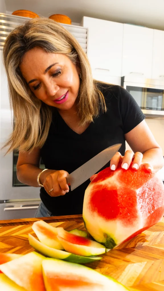 A watermelon, cheese and mint on the table.