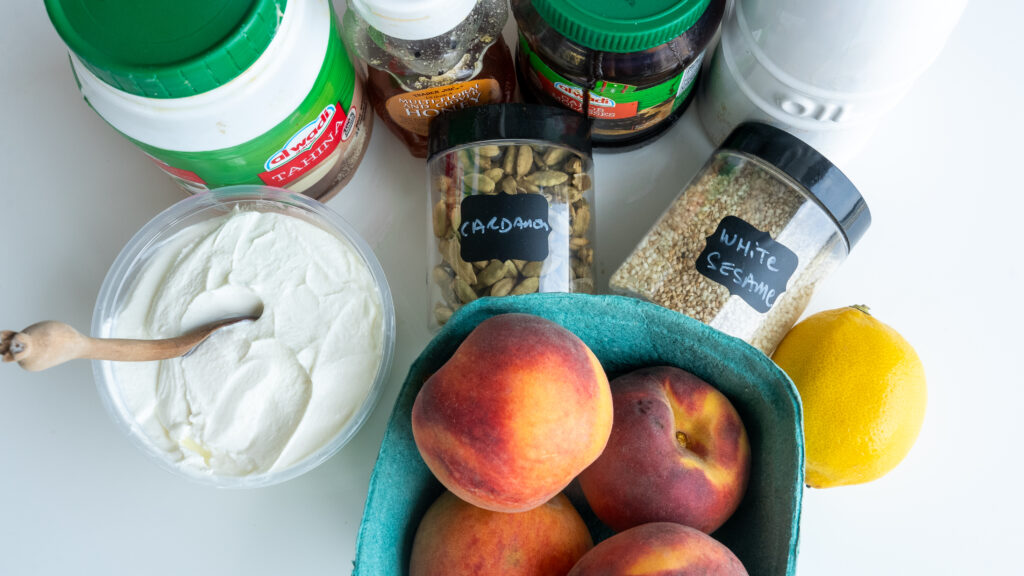 A table topped with bowls of peaches and other food.