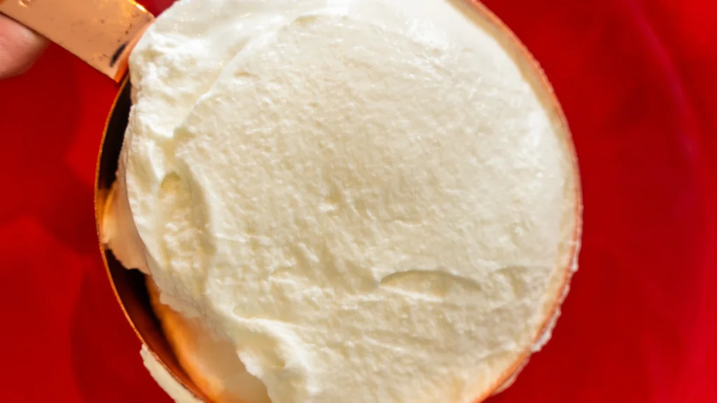 A close up of some ice cream on top of a red plate