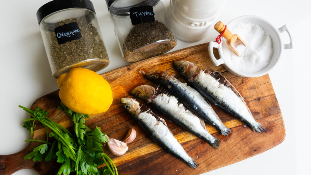 A wooden cutting board with some fish on it