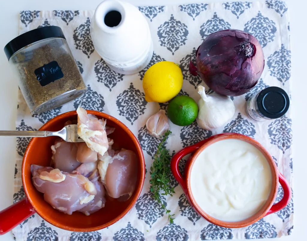 A table topped with bowls of food and sauces.