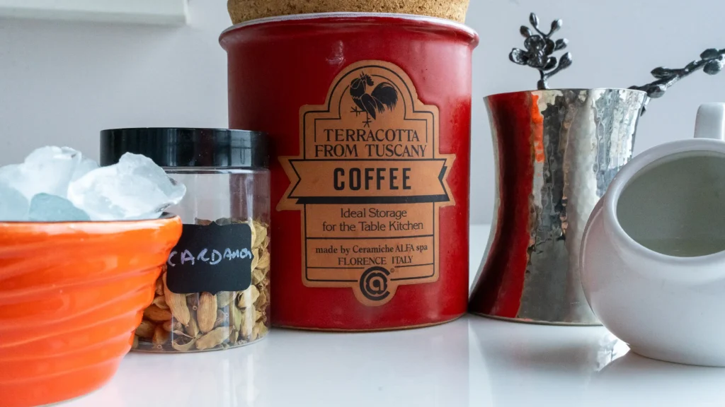 A coffee container and some other items on the counter.