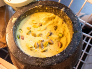 A bowl of food is sitting on the stove.